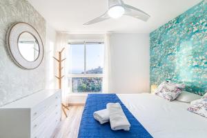 a bedroom with a bed and a mirror at Espejo del Mar in Almería +21 photos