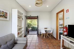 a living room with a couch and a table at Casa de Andrães Magnolias in Marco de Canaveses
