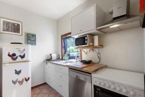 a small kitchen with a refrigerator and a microwave at Casa de Andrães Magnolias in Marco de Canaveses