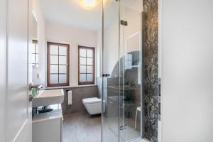 a bathroom with a shower and a toilet and a sink at Werner-Senger-Haus Limburg in Limburg an der Lahn +57 photos