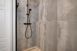 a shower with a shower head in a bathroom at Meerzeit in Mellnitz +33 photos