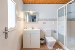 a bathroom with a toilet and a sink and a shower at Vivero El Suso in La Manga del Mar Menor +17 photos