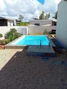 a swimming pool in the backyard of a house at Naturo Villa 16 in Poste Lafayette