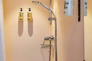 a shower door with utensils hanging on a wall at Chalet Sonneck - Seefeld in Seefeld in Tirol +147 photos