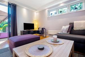 a living room with a couch and a coffee table at Fewo Birkenallee - Lavendel in Deinste