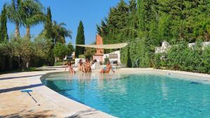 a group of people playing in a swimming pool at Villa Dammusello in Marsala
