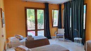 a room with two beds and a large window at Villa Dammusello in Marsala +53 photos
