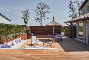 a patio with purple furniture and a gazebo at Ca' Marano Apartments in Centro