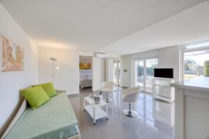 a white living room with a couch and a table at Residence Margherita in Ugento