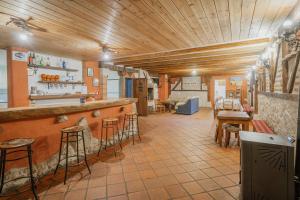 a restaurant with a bar with stools at El Pico Llanillo in San Miguel del Arroyo