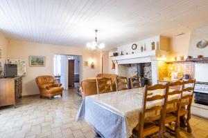 a kitchen and dining room with a table and chairs at Le haut Picot in Bussac