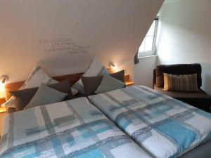 a bedroom with a bed with pillows on it at Ferienwohnung Zur Basemicke in Schmallenberg
