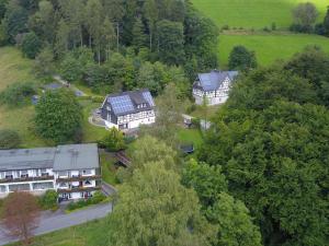 an aerial view of a house in the trees at Ferienwohnung Zur Basemicke in Schmallenberg