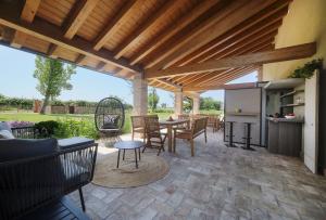 a patio with a table and chairs under a wooden pergola at Ca' Marano Apartments in Centro