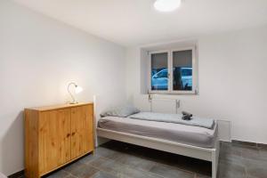 a small bedroom with a bed and a window at Haus Schliengen in Schliengen