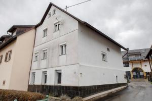 a white building with a cross on the side of it at Haus Schliengen in Schliengen