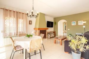 a living room with a table and a fireplace at Disfruta De La Costa Brava in Lloret de Mar