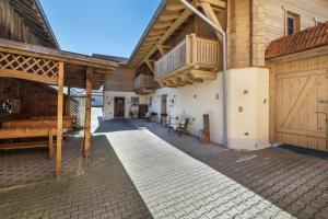 a large wooden building with a porch and a balcony at Ferienwohnung Stub´n in Freyung +16 photos