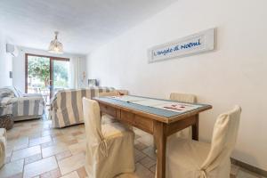 a dining room with a ping pong table and chairs at L'Angolo di Noemi - Chia in Chia