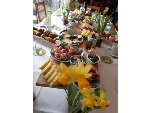 a buffet of cheese and meats and flowers on a table at Gästehaus 26 I 2 in Bad Urach +89 photos