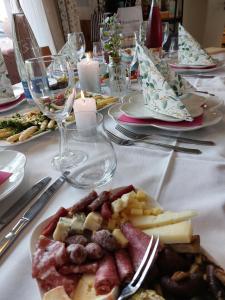 a table with a plate of food and wine glasses at Gästehaus 26 I 2 in Bad Urach