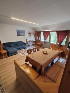 a living room with a table and a couch at Casa Rita - Pila in Gressan