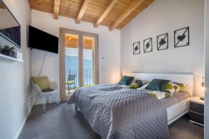 a bedroom with a bed and a balcony at Casa Panoramica in Tignale +21 photos