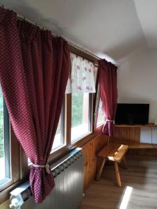a living room with two windows and a couch at Casa Rita - Pila in Gressan
