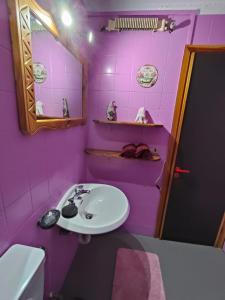 a purple bathroom with a sink and a mirror at Casa Rita - Pila in Gressan +31 photos
