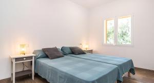 a white bedroom with a bed and a window at Sa Costa in Campos +34 photos