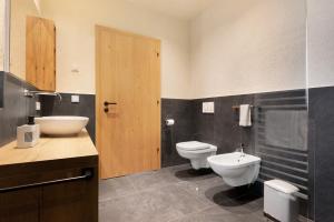 a bathroom with a toilet and a bidet and a sink at Ratscheinerhof App Gipfelglück in Lazfons +27 photos