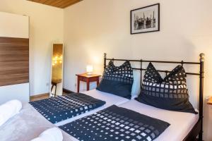 a bedroom with a bed with blue and white pillows at Ferienwohnung Cherine in Gailingen