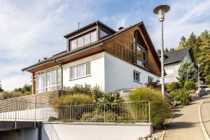 a white house with a brown roof at Ferienwohnung Cherine in Gailingen