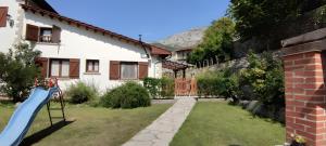 a house with a slide in the yard at Apartamento Rural Jana in Alles +29 photos