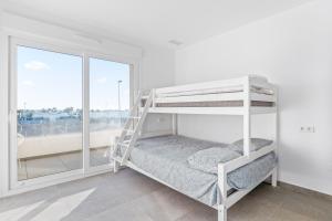 a white bunk bed in a room with a window at El Sueño in Orihuela +17 photos