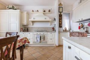 a kitchen with white cabinets and a stove at Casa Zanoni in Arco +27 photos