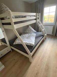 a couple of bunk beds in a room at Ferienhaus auffm Hebberg in Attendorn