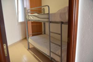 a bunk bed in a small room with a bunk bedscribed at Apartamentos AR Dosjoimi in Lloret de Mar +43 photos