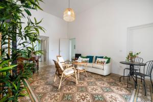 a living room with a table and chairs and a couch at Exclusive Maison Valentina in Monopoli