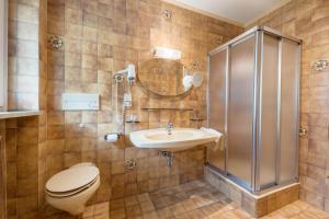 a bathroom with a toilet and a sink and a shower at Residence Kronstein - Fewo 4 in Tesimo +11 photos