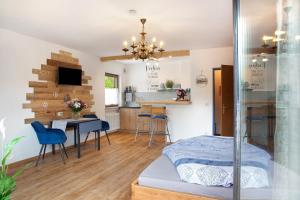 a bedroom with a bed and a table and chairs at Aschaubichl - Wohnung Enzian in Grainau