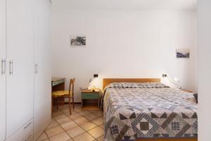 a bedroom with a bed and a desk and a chair at Rustico Spagnol 1 in Tignale +32 photos