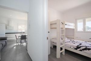 a bedroom with a bunk bed and a desk at Apartamento Marei 3 in Cala Blanca +25 photos