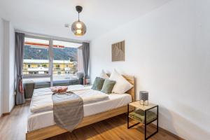 a bedroom with a bed with a large window at The view 2 in Bad Reichenhall