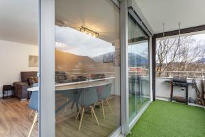 a glass house with a view of the mountains at The view 2 in Bad Reichenhall