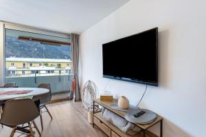 a living room with a flat screen tv on a wall at The view 2 in Bad Reichenhall
