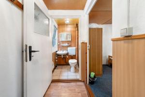 a bathroom with a toilet and a sink at Bungalow 32 - Kimbucht in Reichendorf +16 photos