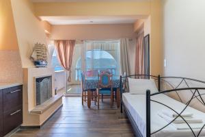 a bedroom with a bed and a table and chairs at Wavedance Accommodation in Salamina +161 photos