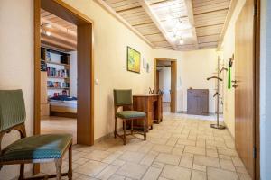 a hallway with chairs and a desk in a room at Urlaub auf dem Hirschhof Stehle in Waldburg
