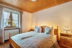 a bedroom with a large bed and a window at Großes Ferienhaus mit Bergblick in Unterwössen